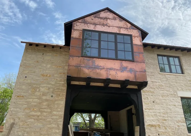 Copper metal panel facade on a stone building for Roof Repair in Madera Acres